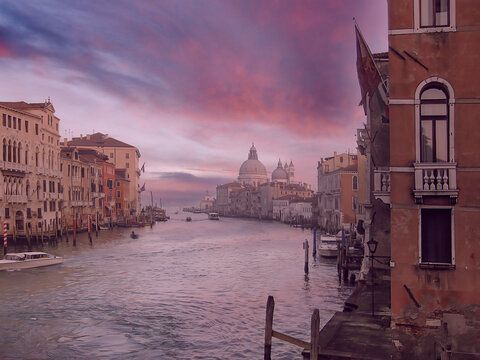 A canal and buildings in Venice at dusk, spectacular skies, nobody
