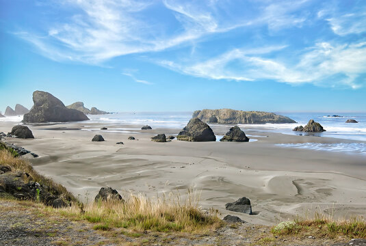 Daytime photo sunny day on a rocky portion of the Oregon coast, boulders, sand, nobody