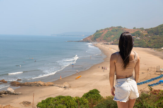 Woman overlooking Vagator Beach from a coastal viewpoint in North Goa