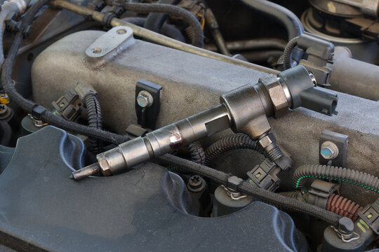 Detail of modern diesel engine repair, closeup of injector at engine after replacing, common rail system