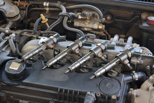 Detail of modern diesel engine repair, closeup of injector at engine after replacing, common rail system