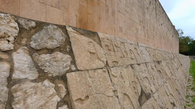 Ancient stone carvings on walls of Great Ball Court in Chichen Itza, Mexico. Detailed Mayan reliefs at historic stadium. Archaeology, heritage, culture and travel destination concept.
