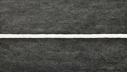 Fototapeta premium A stark white line bisects a dark, textured surface, creating a clean division