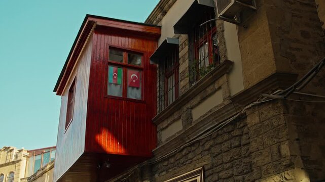 Exterior View of Old Building with Flags in Window