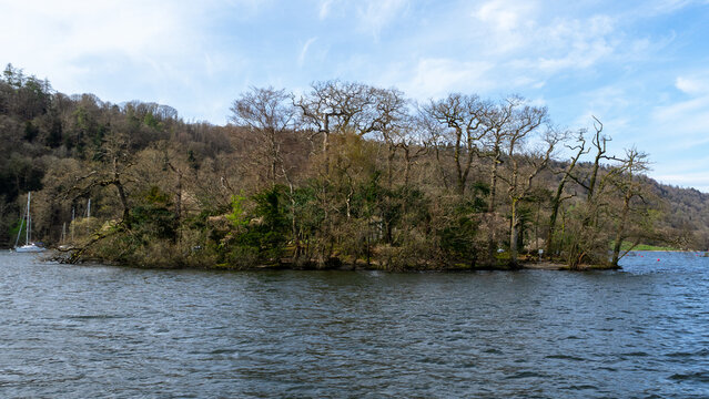 Lake Windermere in the Lake District National Park, where one of the picturesque, small, wooded islands sits in the center