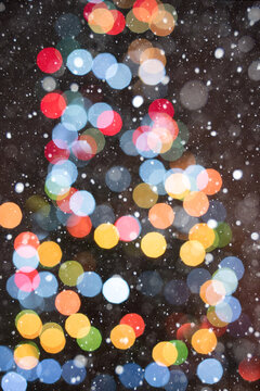 Warm Christmas Tree Bokeh on Brown Background with Falling Snow