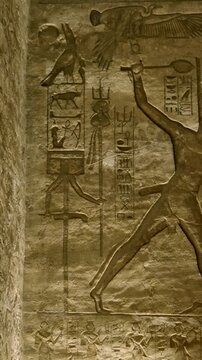 Ancient Egyptian wall paintings with detailed hieroglyphs and ritual scenes inside the Abu Simbel Temple, revealing sacred art, mythology, and preserved history. Egypt.