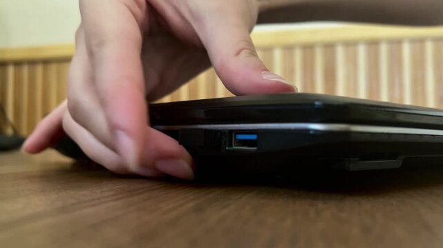 Connecting a USB flash drive to a laptop.Data transfer, external storage, backup, information technology, remote work and digital workflow.