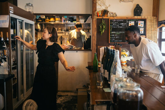 Customer and staff in a Japanese restaurant
