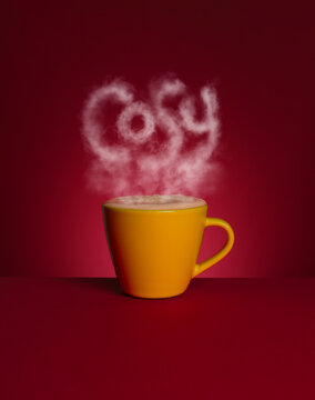 A mug of hot chocolate with the words 'cosy' formed of steam
