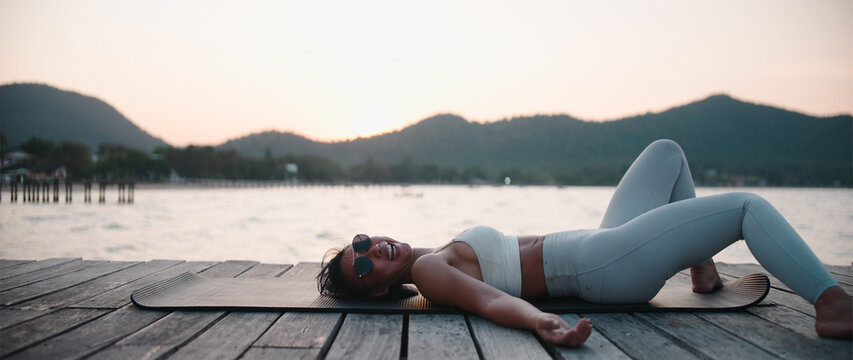 Laughs after failing a yoga pose at golden hour in Chonburi Thailand