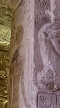 Atmospheric interior of Small Temple of Nefertari at Abu Simbel with carved gods reliefs, hieroglyphics and warm golden lighting, Egypt. Rare inside view for history content.