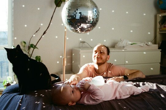 Father and baby enjoying time under disco ball