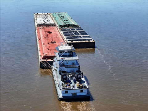 Tug boat pushing a set liquid cargo barges South down the Mississippi River