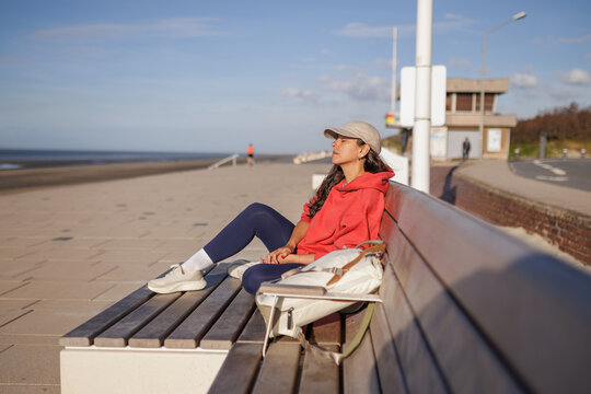 woman relaxing while sitting on the Dunkirk seafront