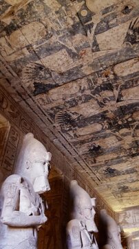 Ancient Egyptian chamber with statues and decorated ceiling inside the Abu Simbel Temple, showcasing sacred architecture, carvings, and timeless spiritual symbolism. Egypt.