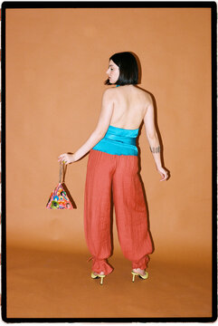 Woman modeling wide leg pants and halter top