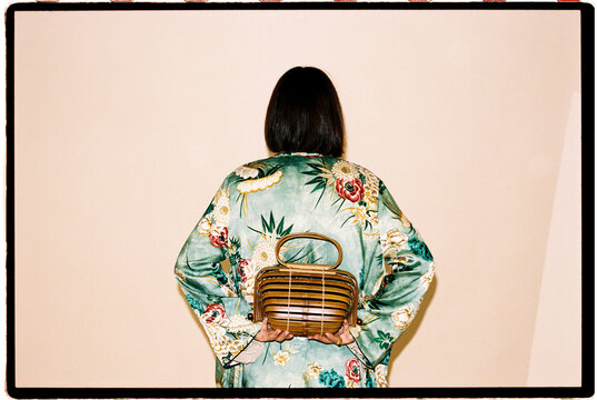 Woman holding wooden handbag