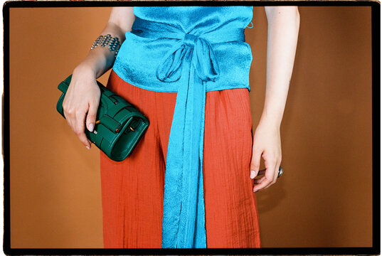 Woman holding green handbag