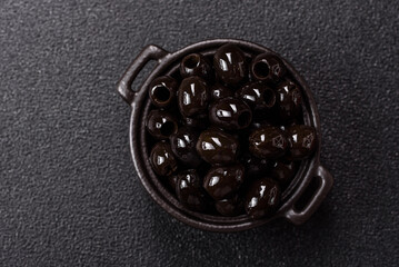 Obraz premium Black canned olives without pits for salads and snacks. Black olives without pits