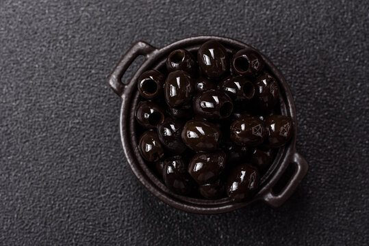 Black canned olives without pits for salads and snacks. Black olives without pits