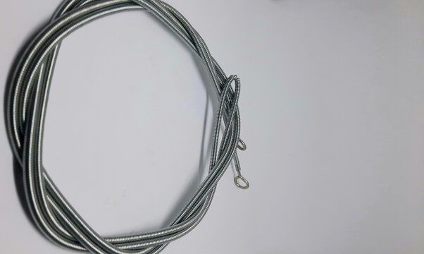 Coiled Steel Curtain Wire with Eyelets on White Background