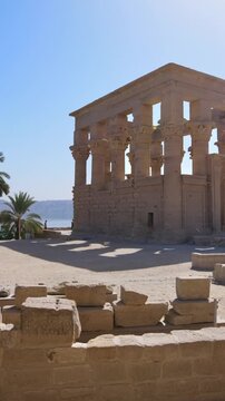 Ancient Egyptian Philae Temple with massive carved stone columns covered in hieroglyphs.