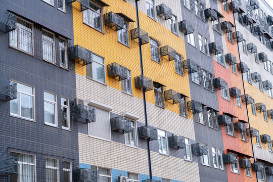 Perspective view of a colorful modern residential building facade. Concept: Contemporary urban housing architecture