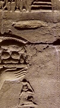Detailed reliefs of ancient Egyptian deities and hieroglyphs carved on the walls of the Philae Temple. Egypt.