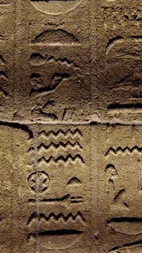 Detailed reliefs of ancient Egyptian deities and hieroglyphs carved on the walls of the Philae Temple. Egypt.