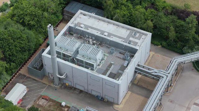 Energy Production Facility With a Tall Chimney and Piping System
