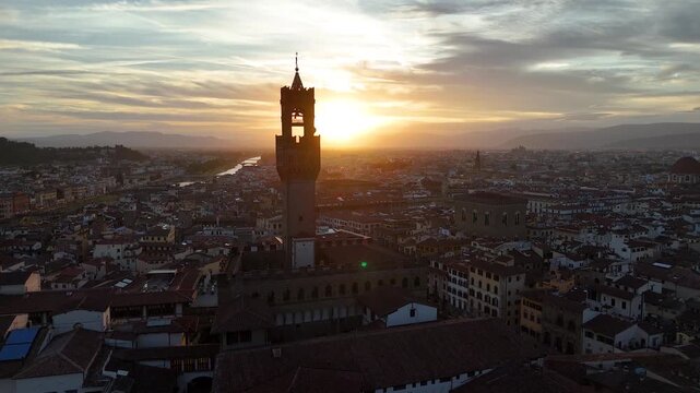 Florence, Italy. Aerial 4K panoramic drone view of the city at sunset or sunrise. Majestic view of the ancient city skyline with basilics, Palazzo Vecchio, bridges, iconic buildings. Europe from above