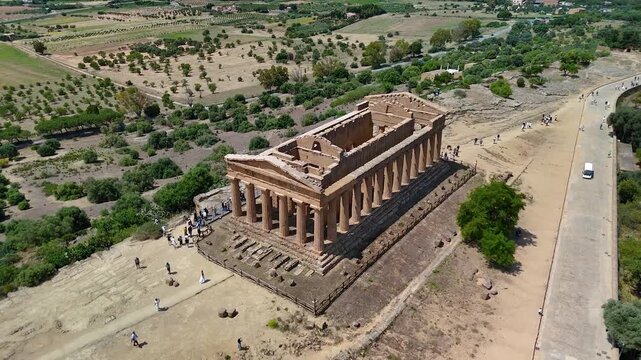 Agrigento in Sicily, Italy. Cinematic aerial drone 4K view of the Temple of Concordia, the largest Doric temple built by the ancient Greeks, in the Valley of the Temples archaeological park.