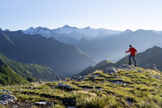 Hiker enjoying the mountain panorama in the morning, Venediger group, behind Dreiherrenkopf, Simonysitze and Gro&szlig;er Geiger, Hohen Tauern, Austria
