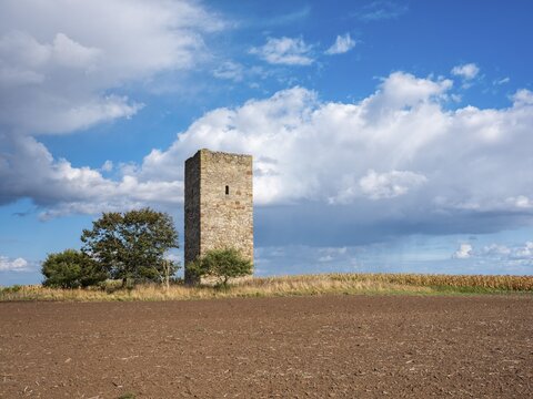 The Blaue Warte in a ploughed field in autumn, medieval watchtower in the Magdeburger B&ouml;rde, blue sky with dramatic clouds and rain showers, Wanzleben-B&ouml;rde, Saxony-Anhalt, Germany