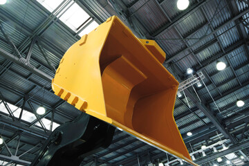 Industrial excavator bucket against the background of an industrial building's ceiling © Aleksandr Matveev
