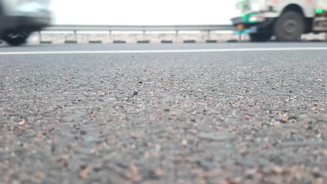 Low Angle Close Up of Vehicles Driving Fast on Asphalt Highway Road