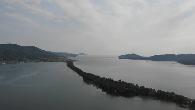 Drone aerial view ascending over the scenic Amanohashidate sandbar and sea, Kyoto, Japan