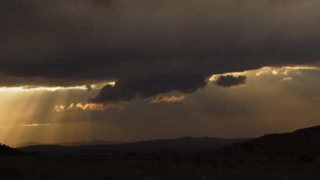 Timelapse of shafts of sun rays and clouds as a storm approaches near Torrey, Utah