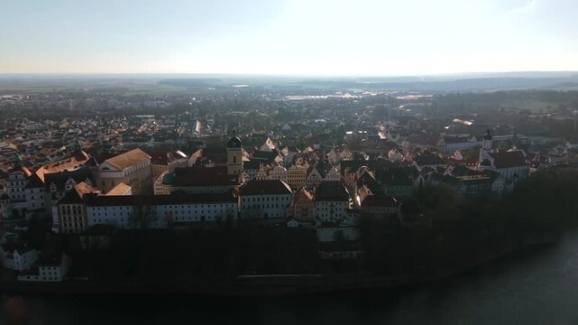 Aerial view of the historic Karlsplatz and Hofkirche church tower in Neuburg an der Donau Upper Bavaria showcasing majestic old quarter architecture and traditional red roofs on a sunny day