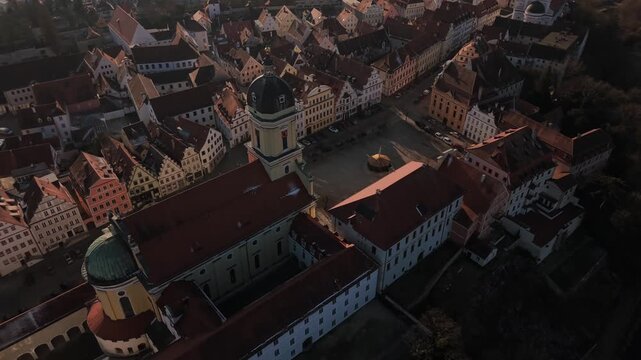 High angle aerial overview of the ancient town center in Neuburg Germany highlighting the landmark church tower of Maria Himmelfahrt and traditional Bavarian architecture from above