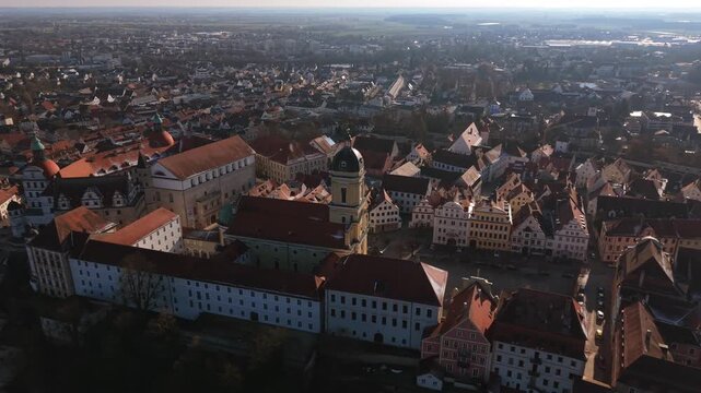 Drone footage tracking over the old town square and palace church in Neuburg Germany capturing a cinematic b roll overview of the architectural heritage in the Danube valley area