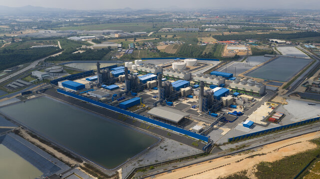 Aerial view of the Sriracha Power Plant GSRC featuring industrial buildings, cooling towers, and large water reservoirs in Tambon Khao Khan Song, Chang Wat Chon Buri, Thailand.