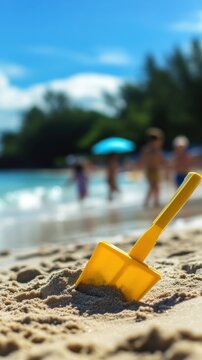 Children beach toy shovel on sunny coast near ocean