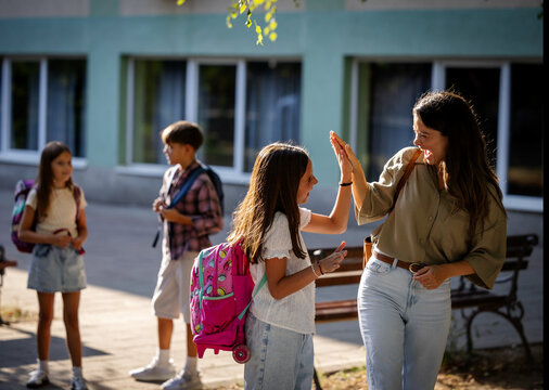 Girl and her mother greet each other after school