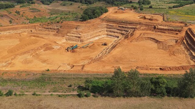 Heavy Machinery Operates at Large Open Pit Excavation Site