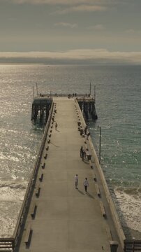 An aerial flyover vertical video of the Newport pier, Newport Beach, California
