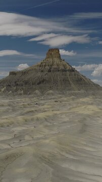 An Aerial Flyby vertical video of Factory Butte near Caineville, Utah