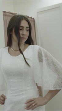 A young woman is trying on wedding dresses, vertical video, St. George, Utah