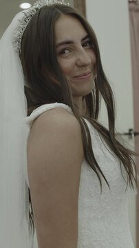 A young woman is trying on wedding dresses, vertical video, St. George, Utah